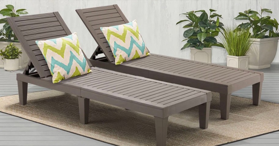 two brown lounge chairs with green and blue striped pillows on patio 