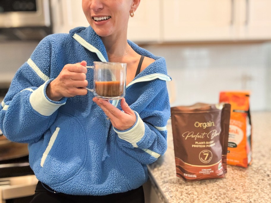 woman holding protein coffee