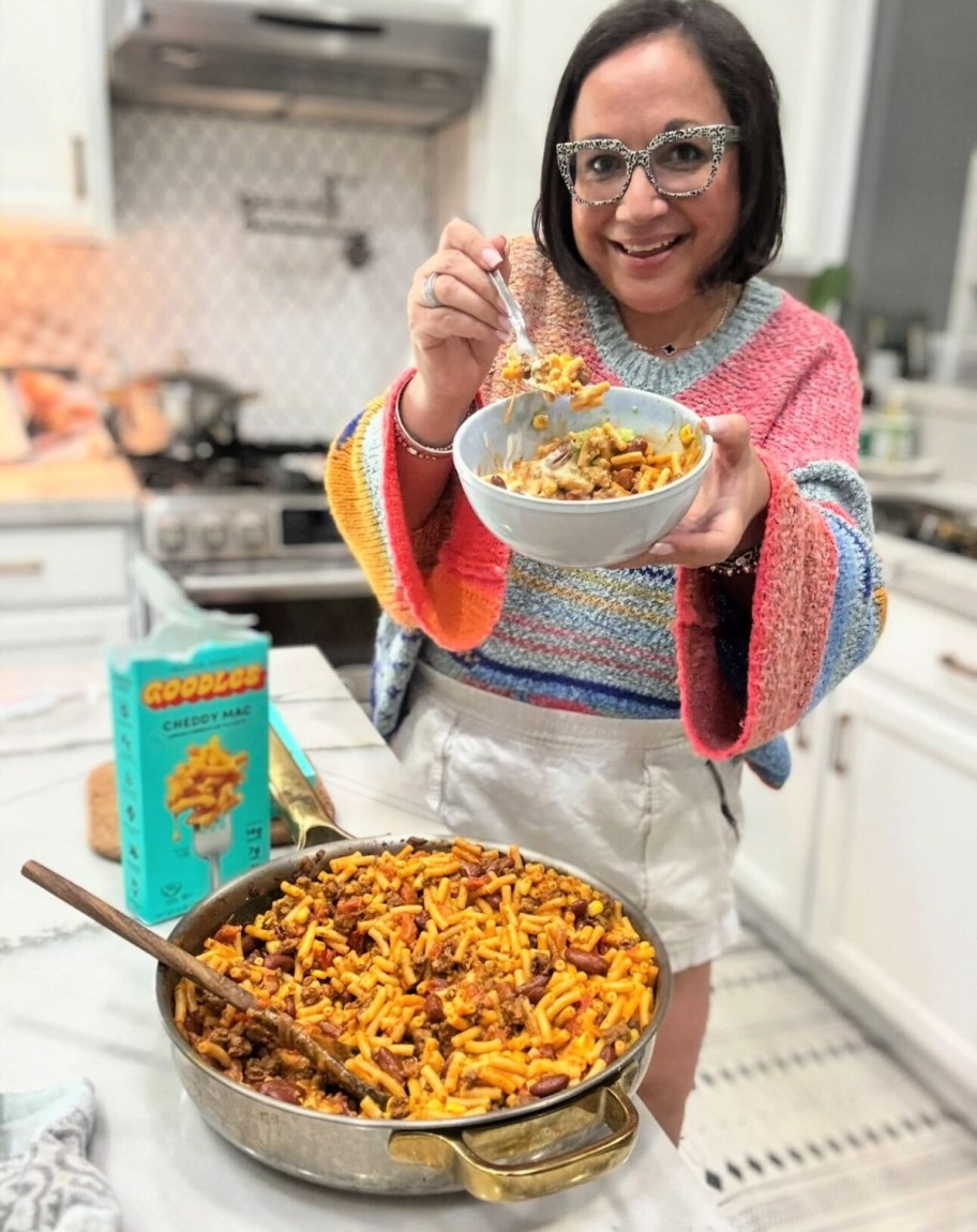 woman making high protein mac and cheese meal with goodles