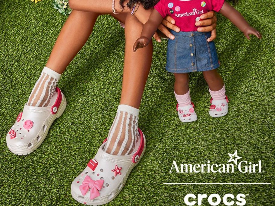 Little girl's feet and American Girl Doll wearing matching Crocs Clogs