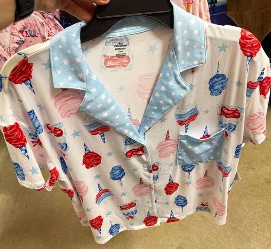 holding up a set of red white and blue cotton candy print pajamas