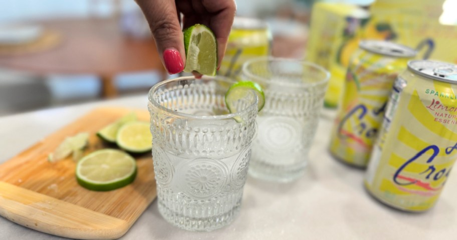 adding fresh lime to sparkling water 