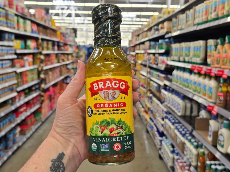 Bragg Organic Vinaigrette Salad Dressing & Marinade bottle in hand in store