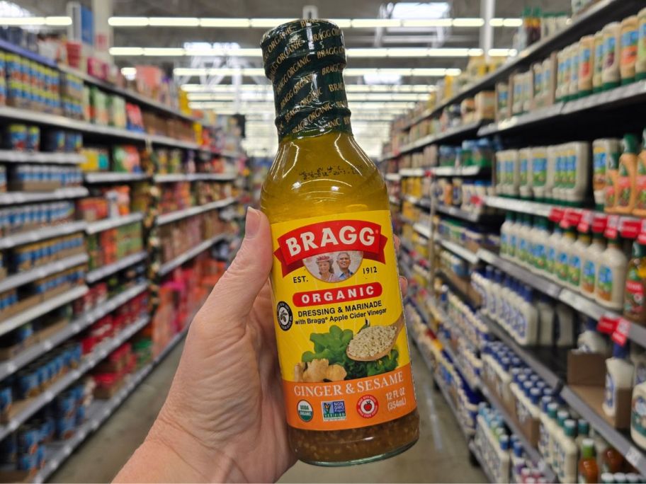 Bragg Organic Ginger Sesame Salad Dressing & Marinade bottle in hand in store