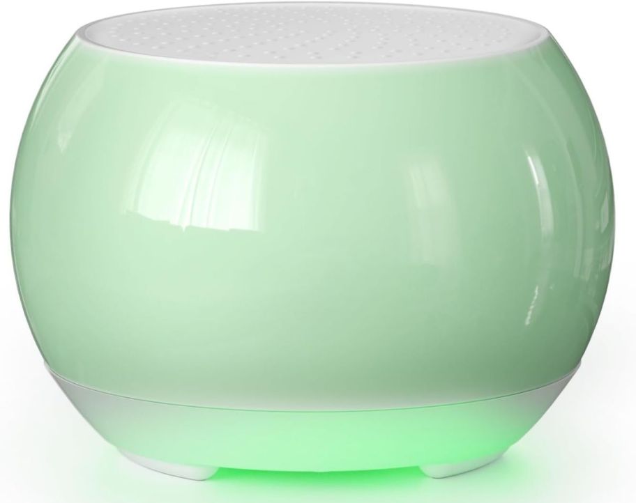 a green ceramic bluetooth speaker with lighted base