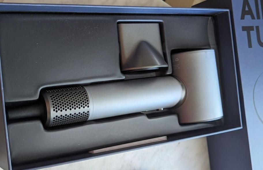 a grey ionic hair dryer shown in its packaging