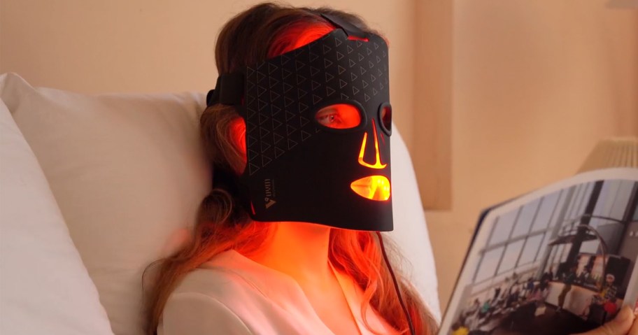 woman wearing black red light therapy mask