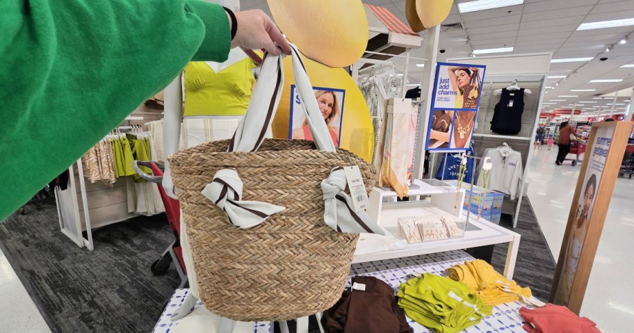 woman holding up a scarf basket tote