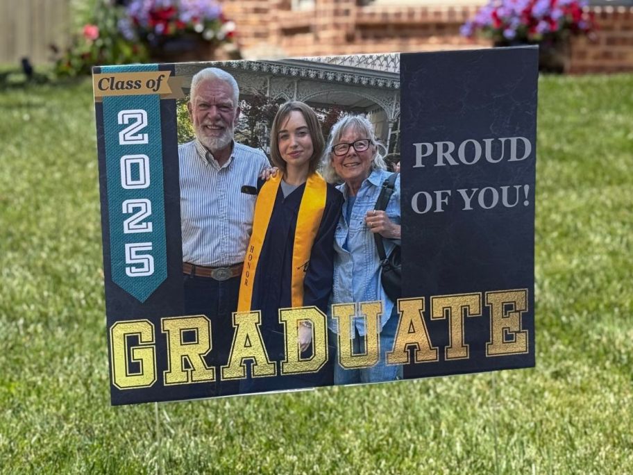 a 2025 graduation sign in yard with a picture on it